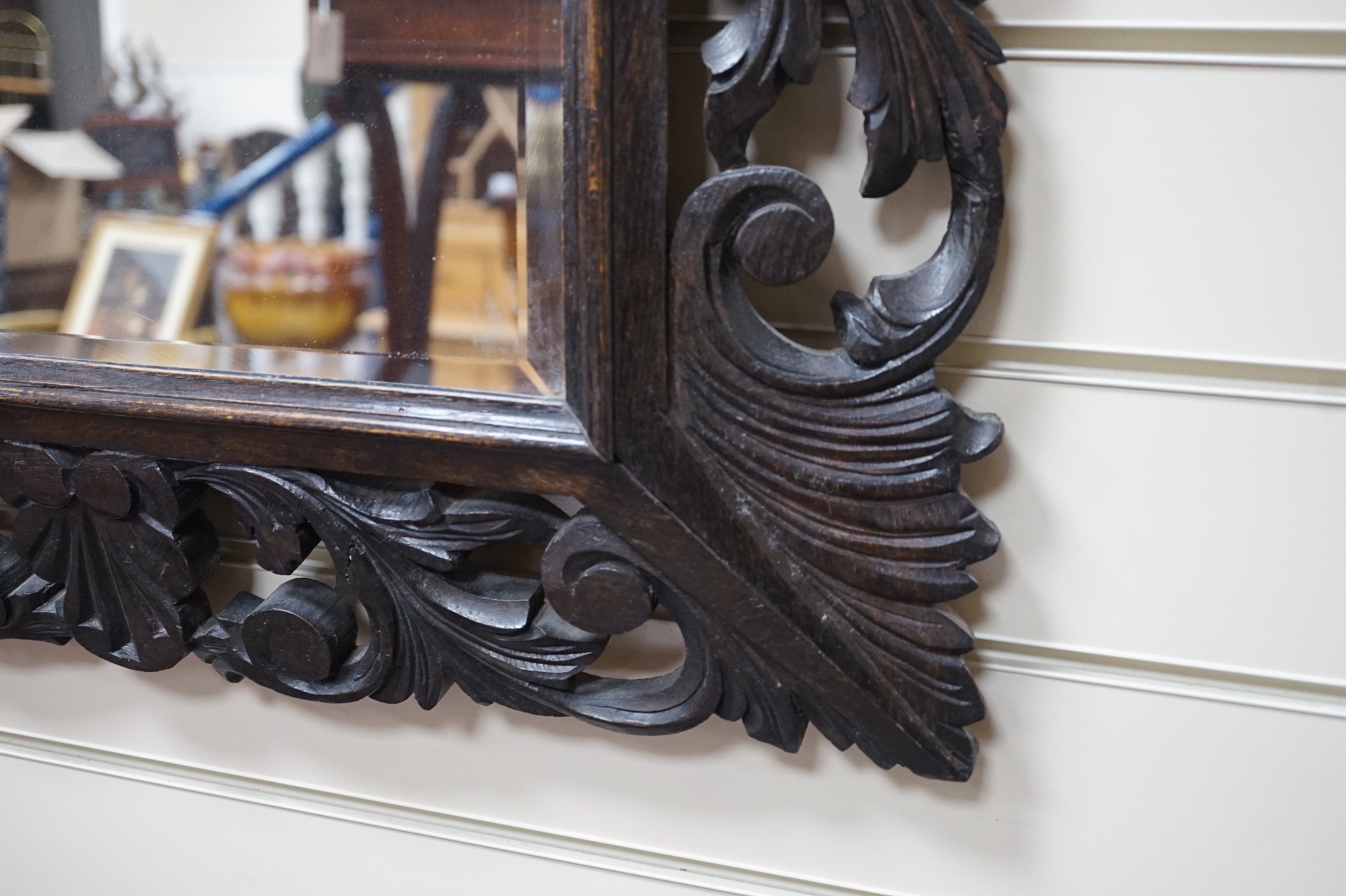 An Edwardian foliate carved oak wall mirror, width 81cm, height 64cm *Please note the sale commences at 9am.